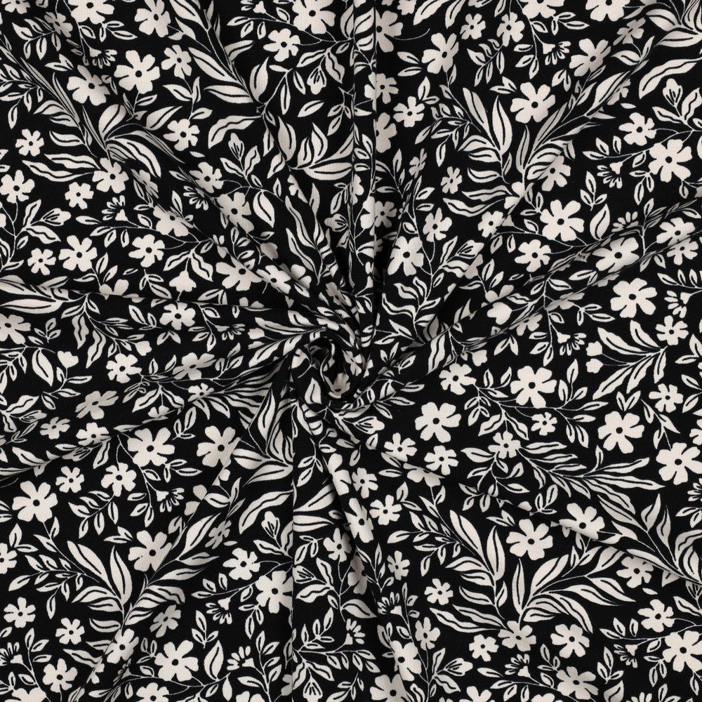 Attēls ar Kokvilnas trikotāža - balti ziedi uz melna 200 g/m² – pieejams Šarlotes audumi