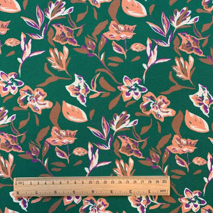 100% viscose fabric - abstract floral pattern on a green background 125 g/m²