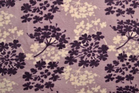 Image of fleece fabric with tree pattern – purple/beige – available online at Šarlotes audumi