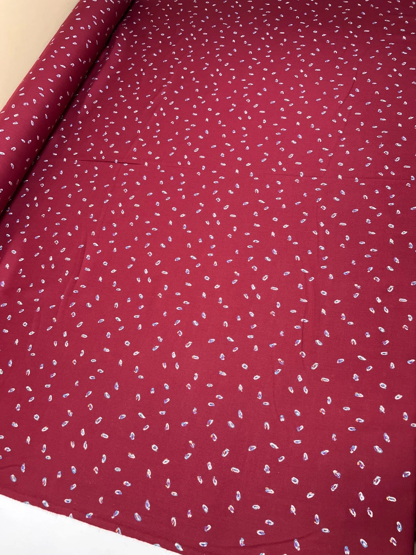 Image of burgundy Italian twill fabric with a subtle pattern – available online at Šarlotes audumi