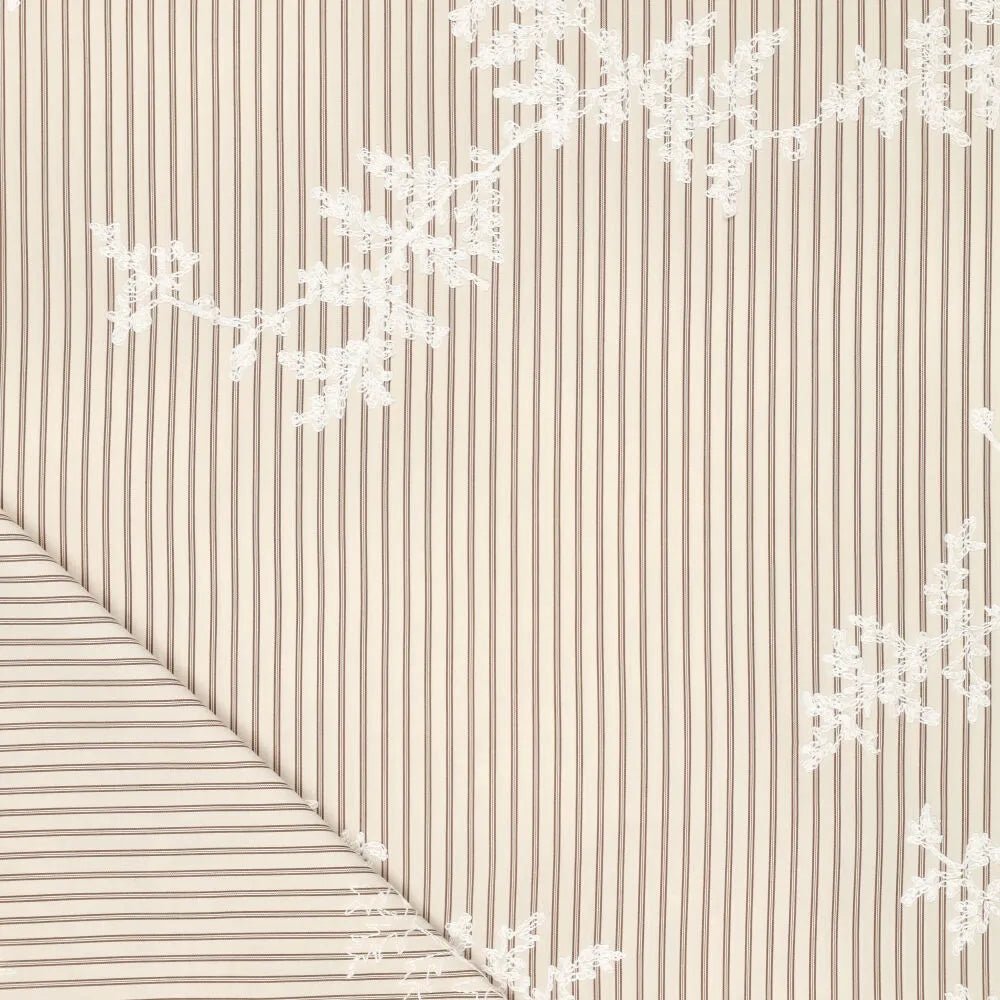 Image of embroidered cotton fabric with stripes and white embroidered flowers – available online at Charlotte's Fabrics