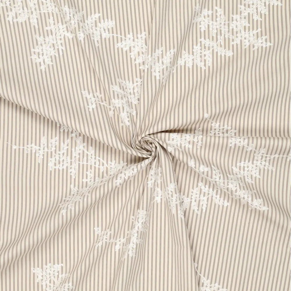 Image of embroidered cotton fabric with lines and white embroidered flowers – available online at Šarlotes audumi
