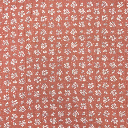 Mousseline - fleurs blanches sur fond orange 130 g/m²