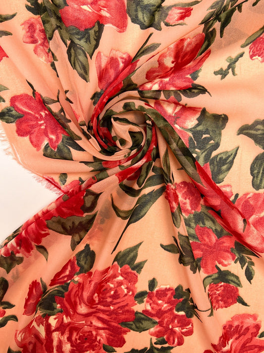 Image of polyamide crepe fabric with a red floral pattern on a beige background – Italy – available online at Šarlotes audumi