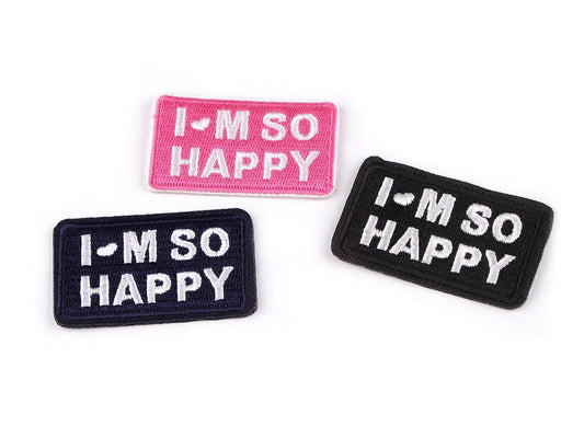 Image of iron-on patch “I’M SO HAPPY” – 3 × 5 cm – available online at Šarlotes audumi